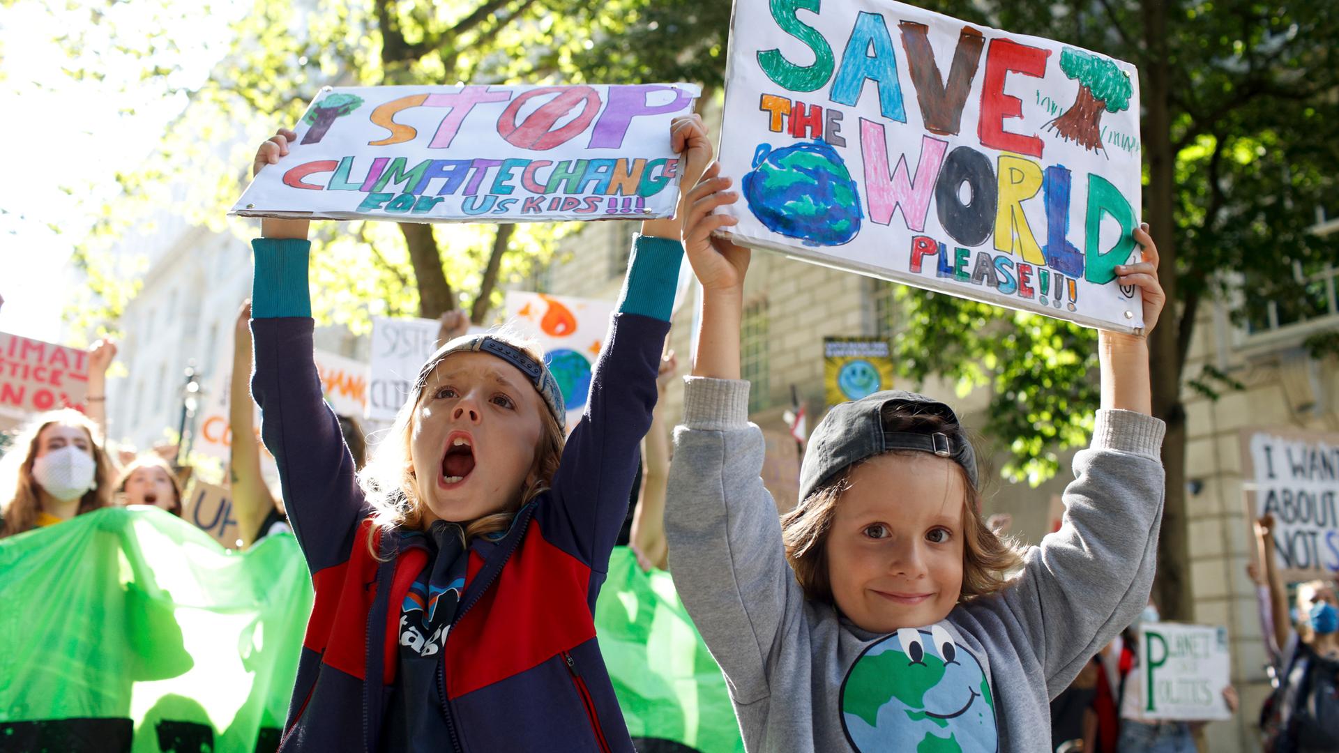 Prostestierende Kinder halten Schilder hoch