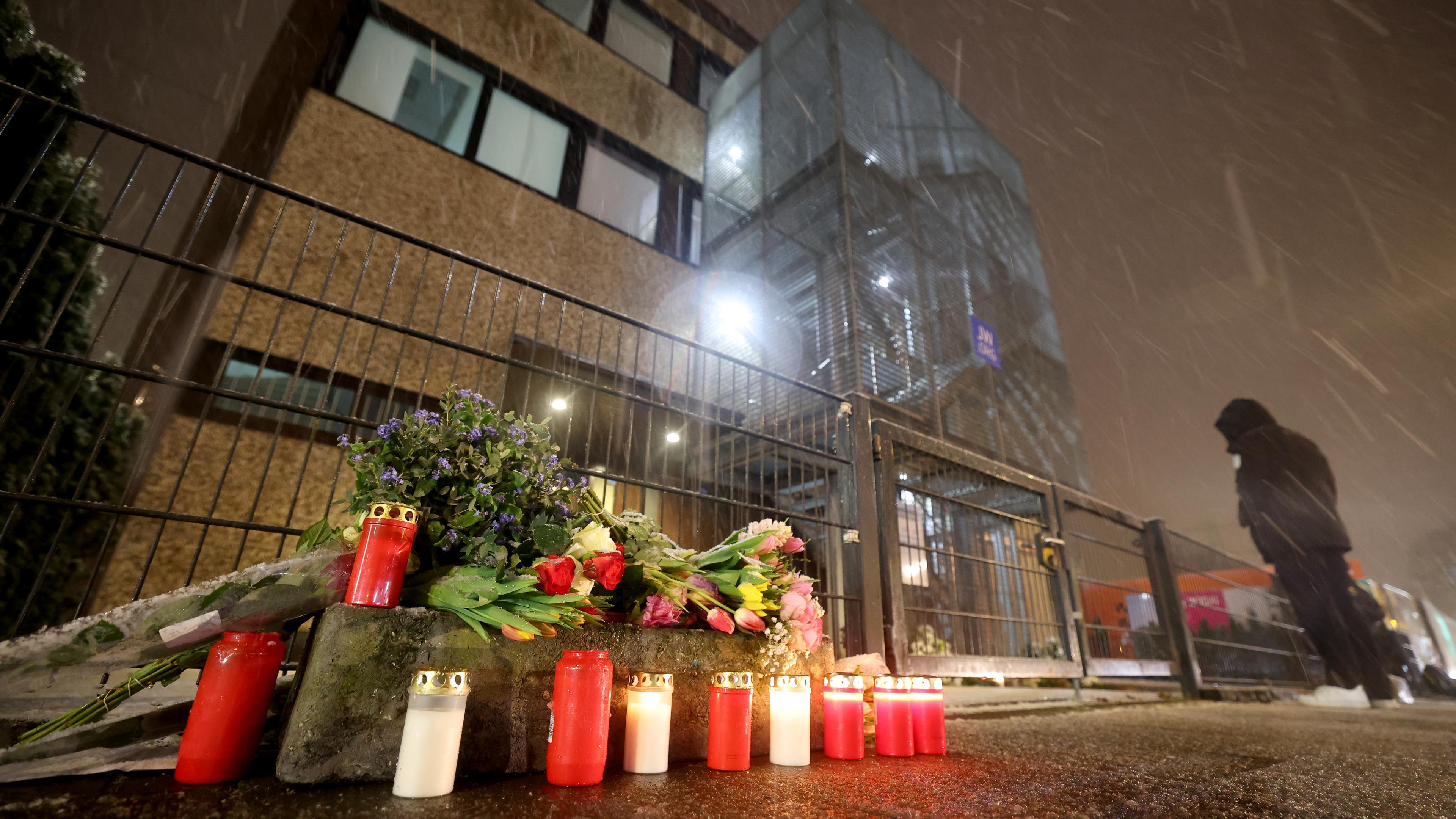 Kerzen und Blumen liegen vor dem Gebäude der Zeugen Jehovas nach der Amoktat