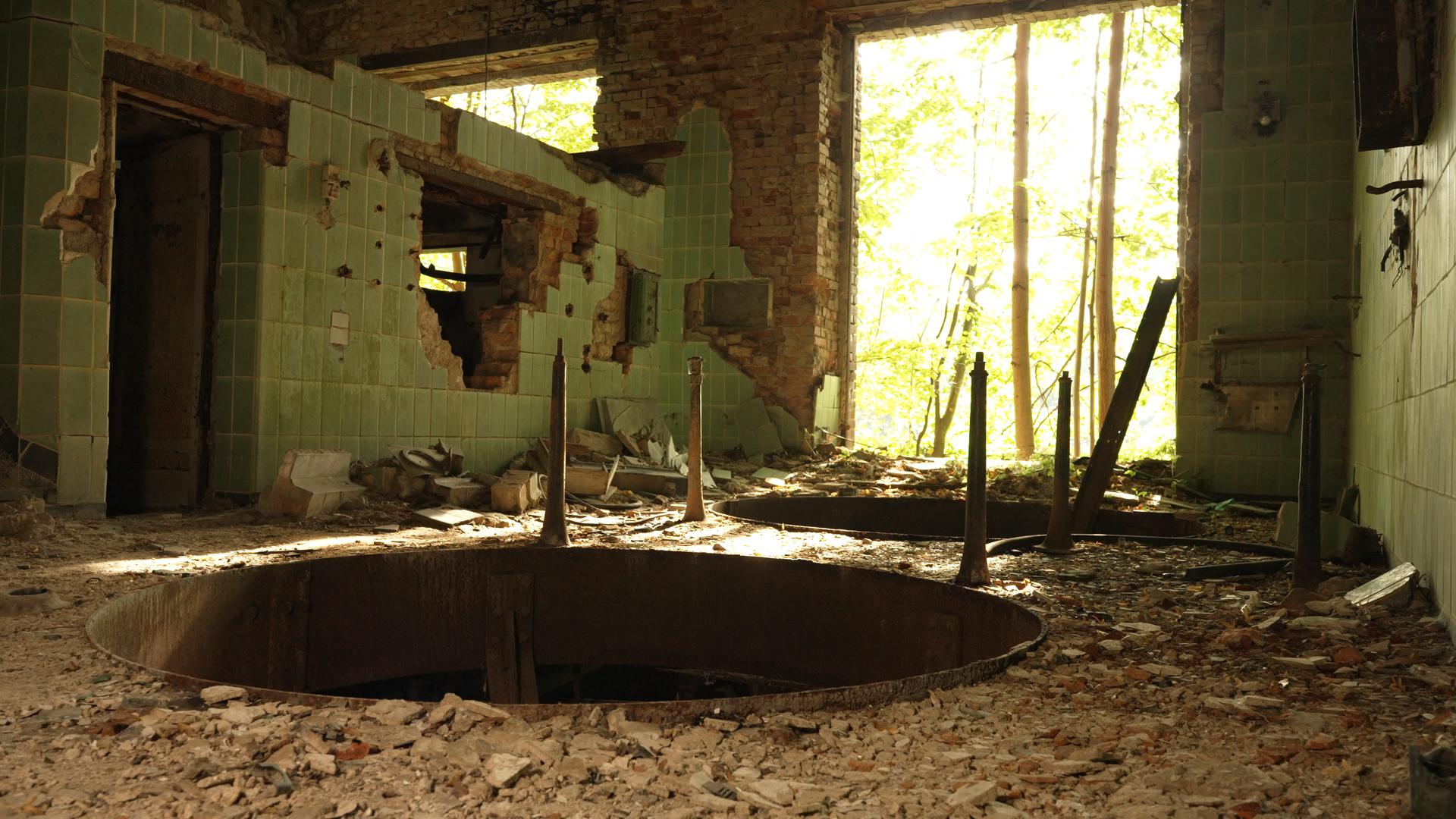 Das Innere einer völlig heruntergekommenen Brauerei-Ruine im brandenburgischen Wiesenburg. Im Vordergund klafft ein großes, rundes Loch im Boden, im Hintergrund blickt man duch einen großen Duchbruch ins Freie.