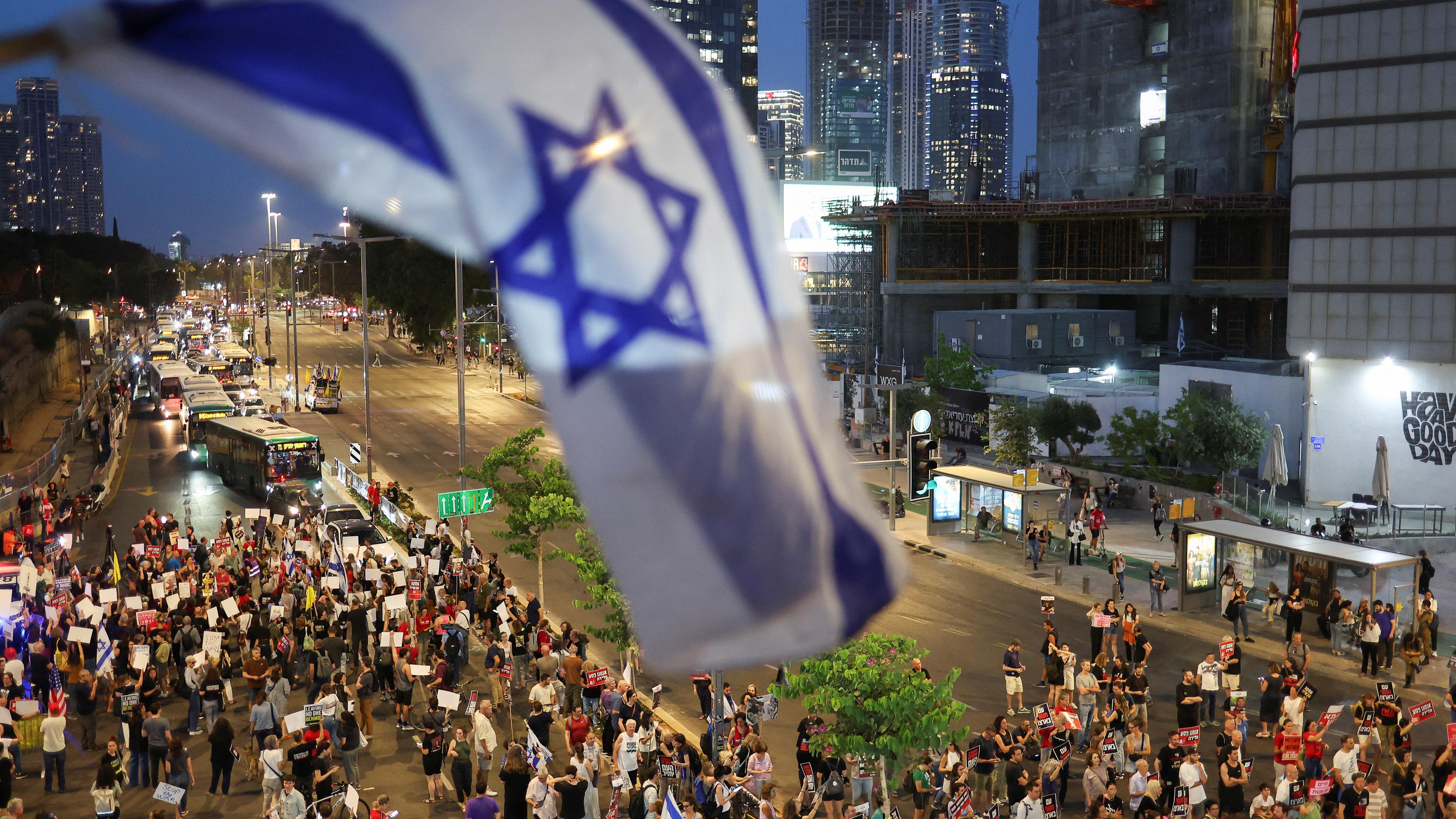 People take part in a protest demanding the immediate release of hostages, in Tel Aviv