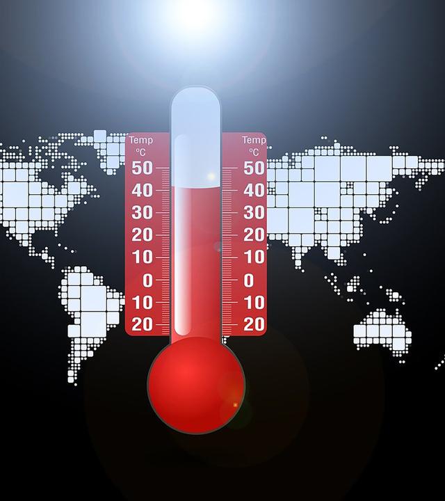 Thermometer über einer Weltkarte