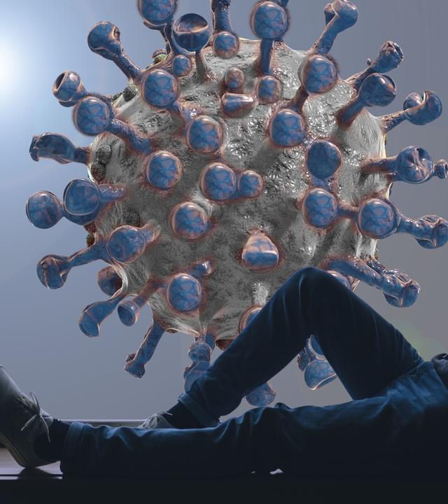 Sitzender Mann, im Hintergrund Corona Virus