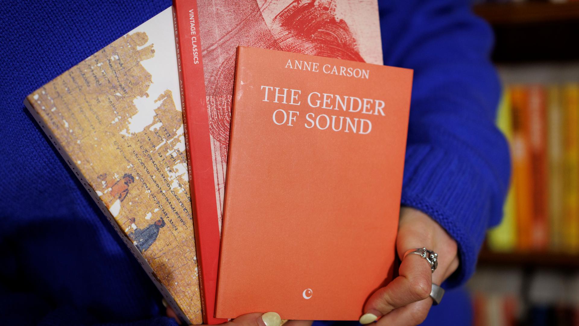 A shopkeeper holds books written by Canadian poet and essayist Anne Carson at a bookshop in central London, Britain, 08 October 2026