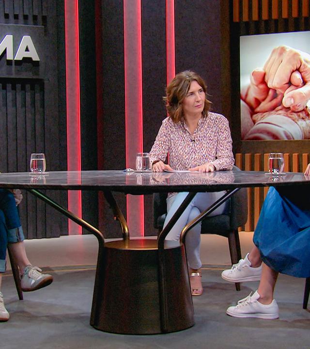 Drei Frauen sitzen im Studio an einem Tisch.