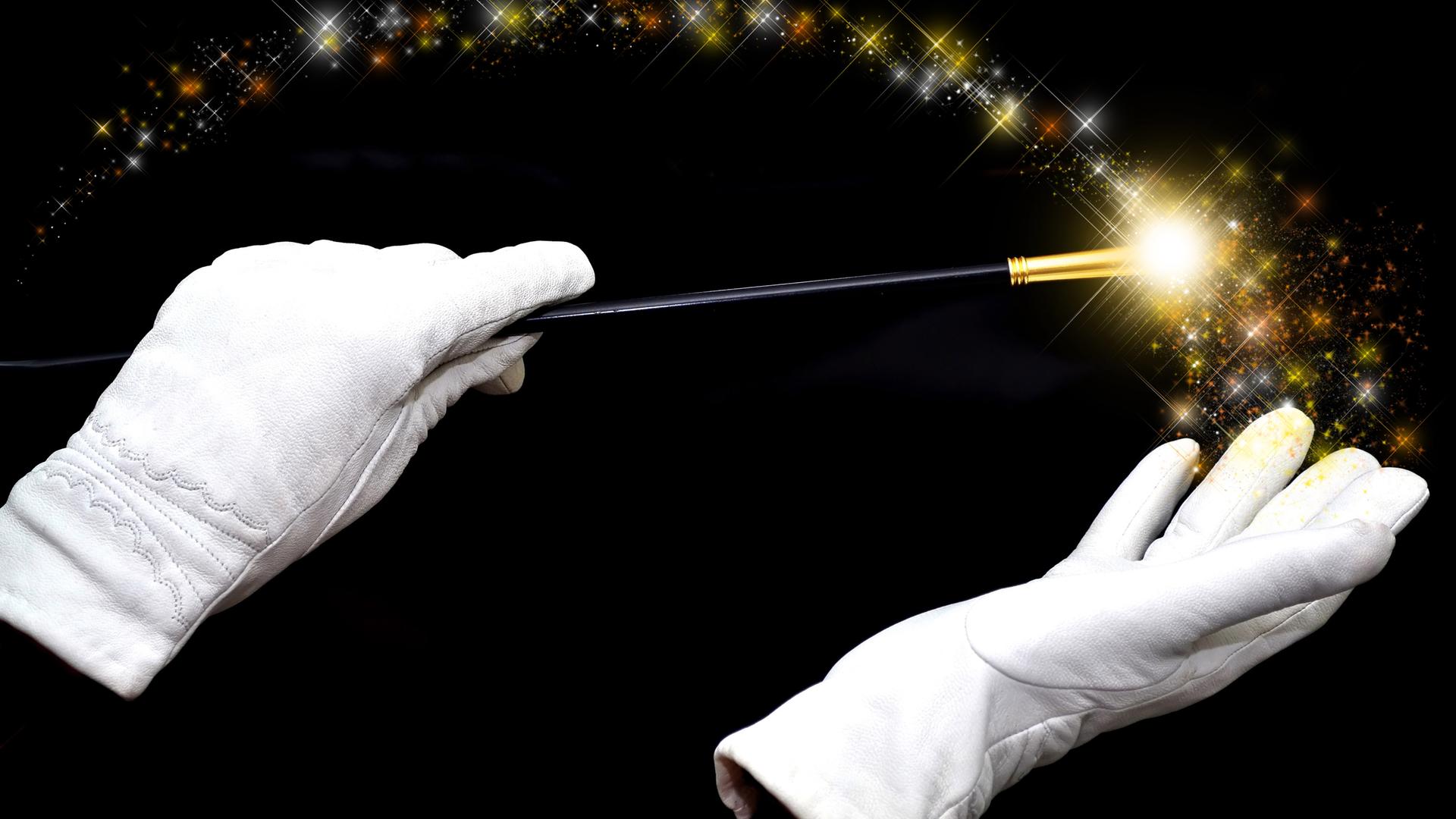 haende eines zauberers mit zauberstab