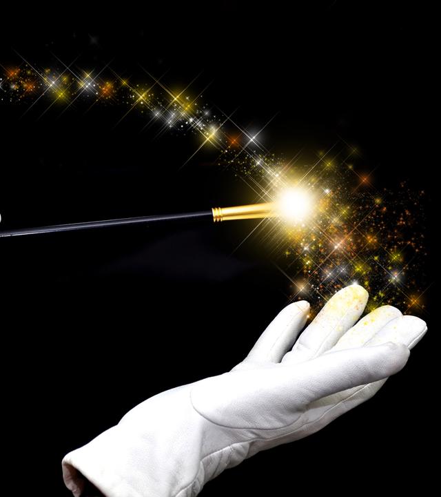 haende eines zauberers mit zauberstab