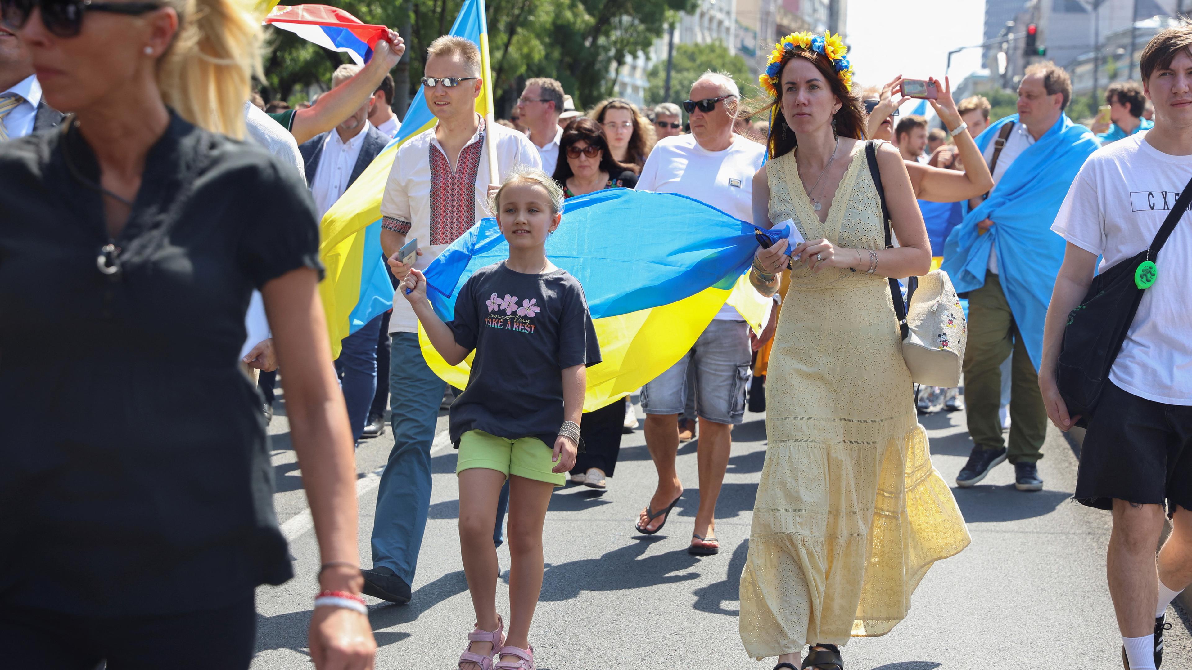 People take part in a march of solidarity to mark Ukraine independence day in Belgrade