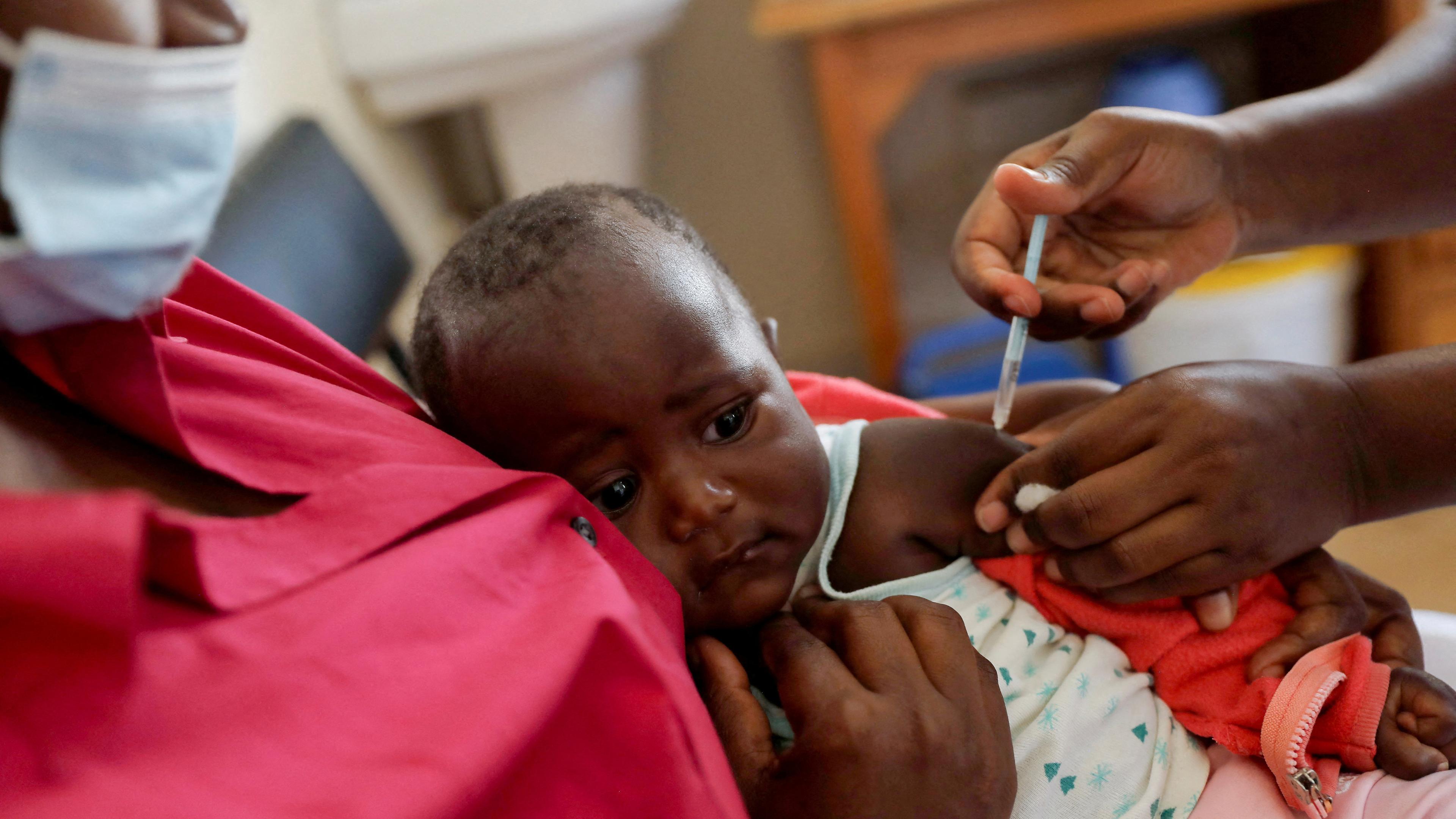 FILE PHOTO: A nurse administers the malaria vaccine to an infant at the Lumumba hospital in Kisumu