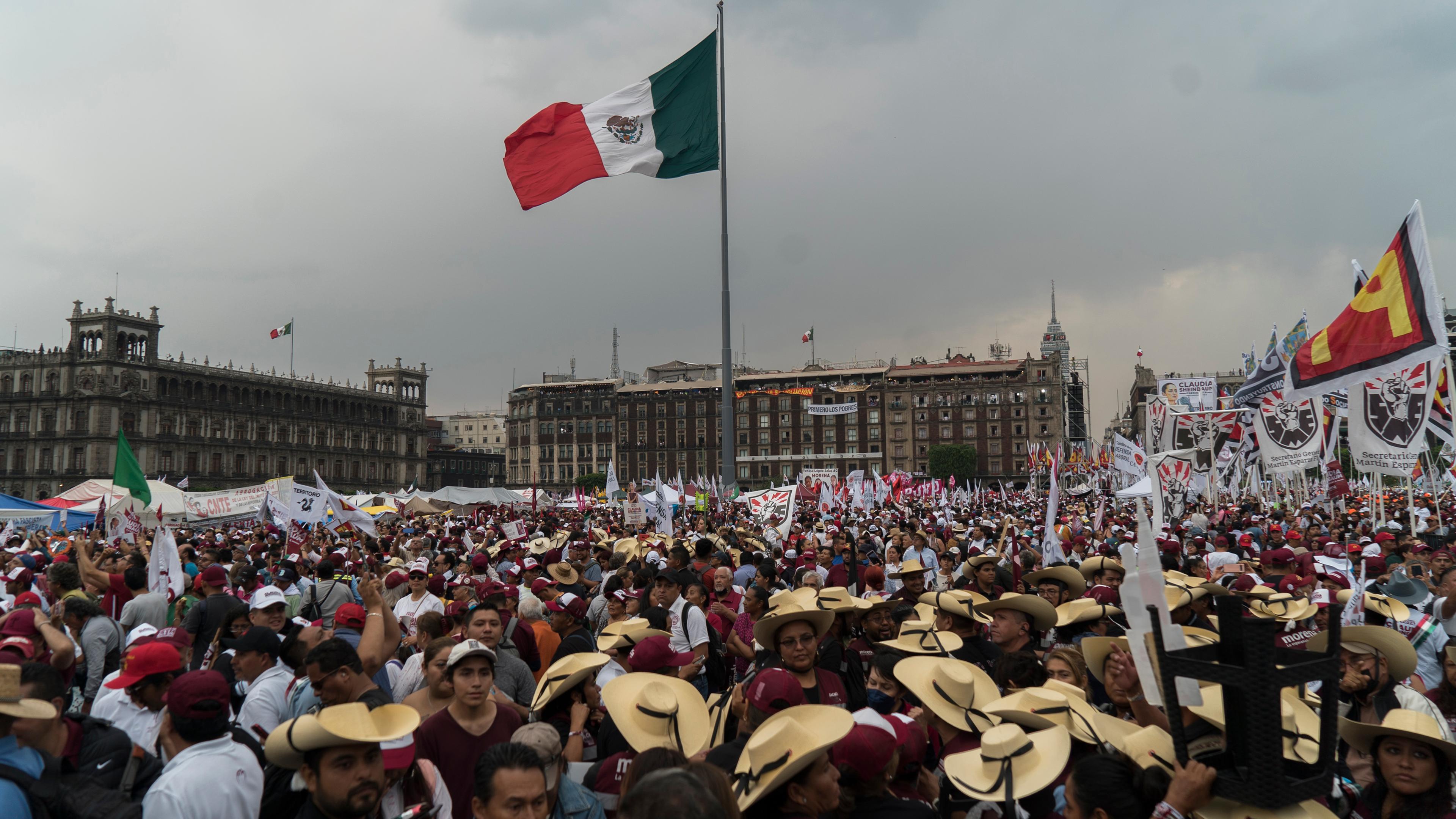 eine große Menschenmengen nimmt an einer Abschlusskundgebung auf dem Zocalo teil, in der Mitte ist die Flagge von Mexiko gehosst