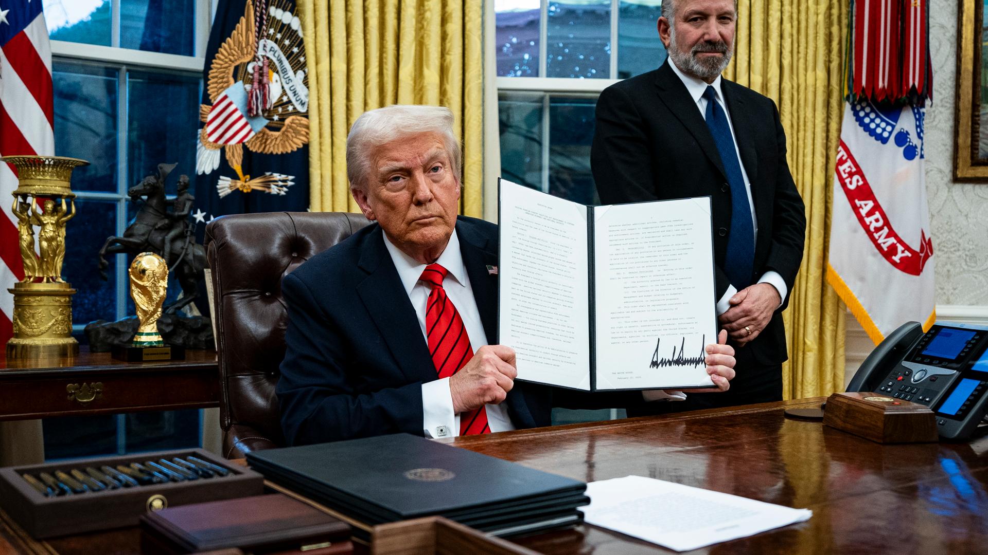 US President Trump signs executive order in Oval Office