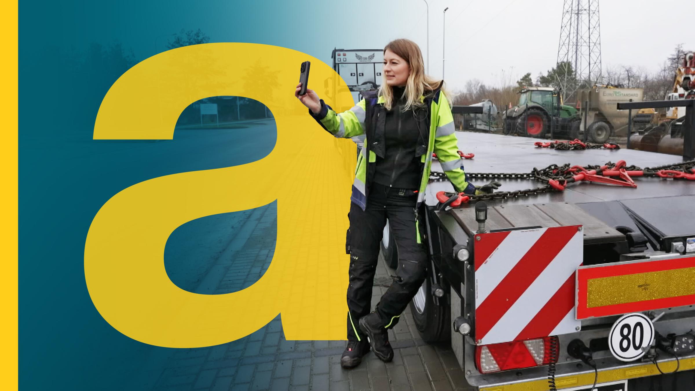 großes Auslandsjournal a im Vordergrund, daneben Frau steht mit Handy neben der Ladefläche von einem LKW