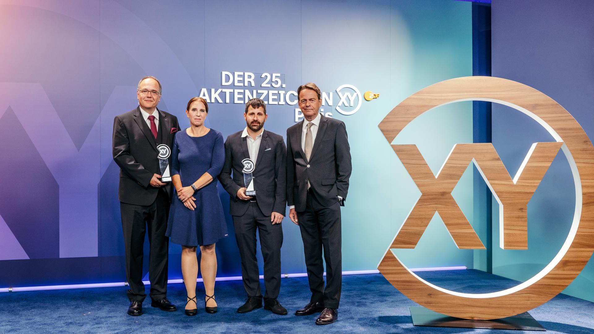 "XY-Preis 2026: Messerangriff gestoppt": Die Preisträger Dr. Thomas Krull, Dr. Annemarie Krull und Daniel Kartens mit Moderator Rudi Cerne (von links nacht rechts).