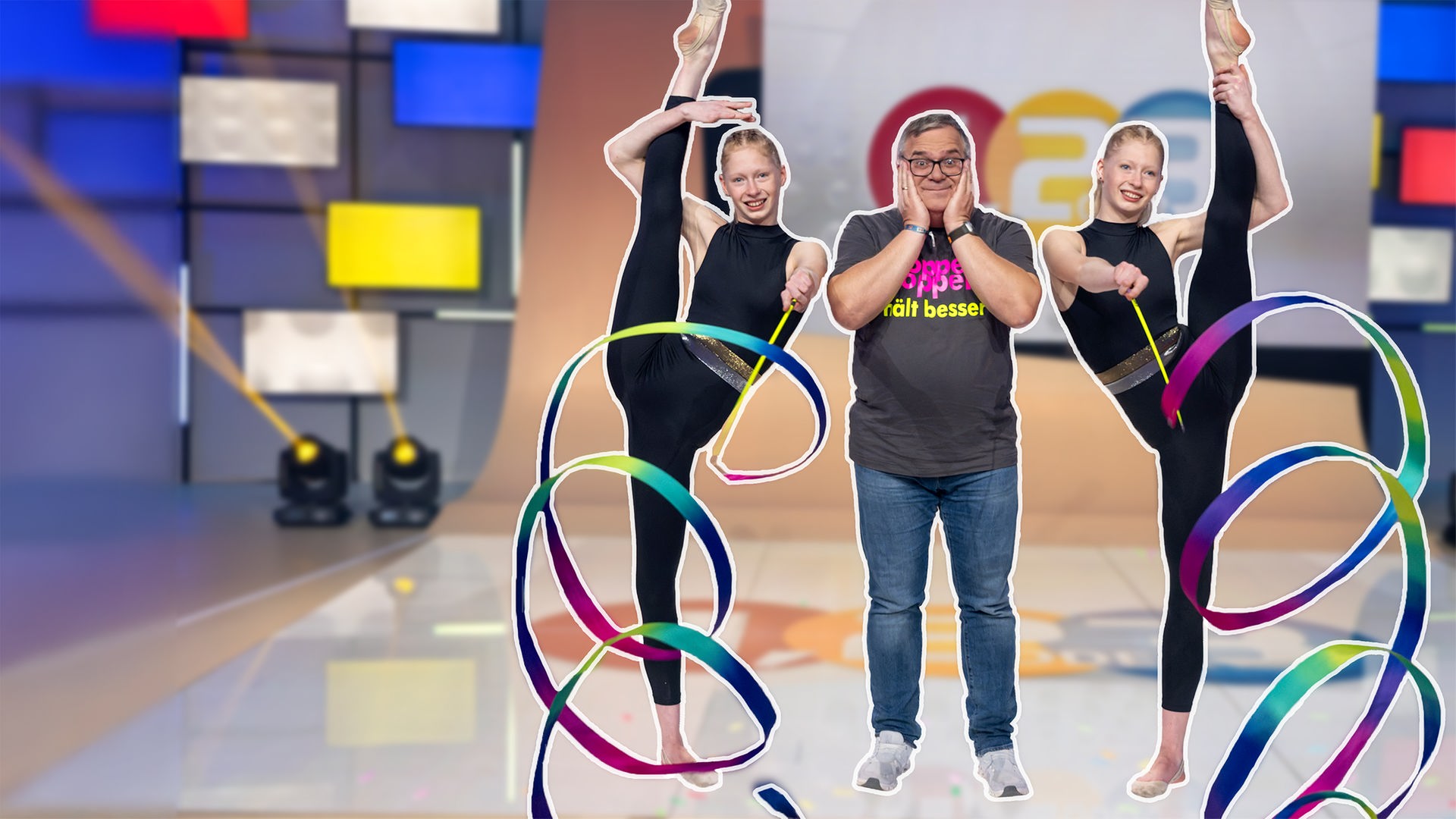 Elton steht zwischen den Zwillingen Nadiia und Veronika