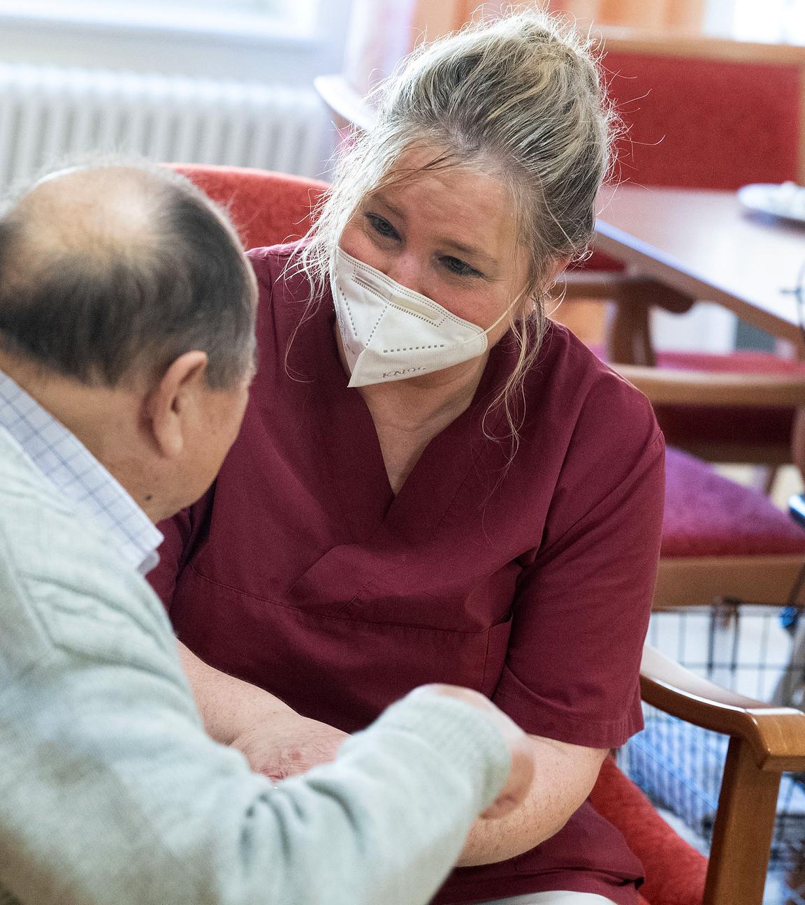 Altenpflegerin mit Seniorin im Rollstuhl, aufgenommen am 23.02.2022 in Niederstetten (Baden-Württemberg)