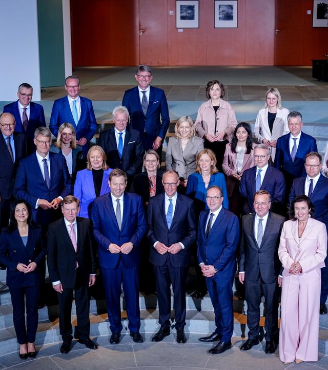 Bundeskabinett steht gemeinsam für Foto auf Stufen zusammen.