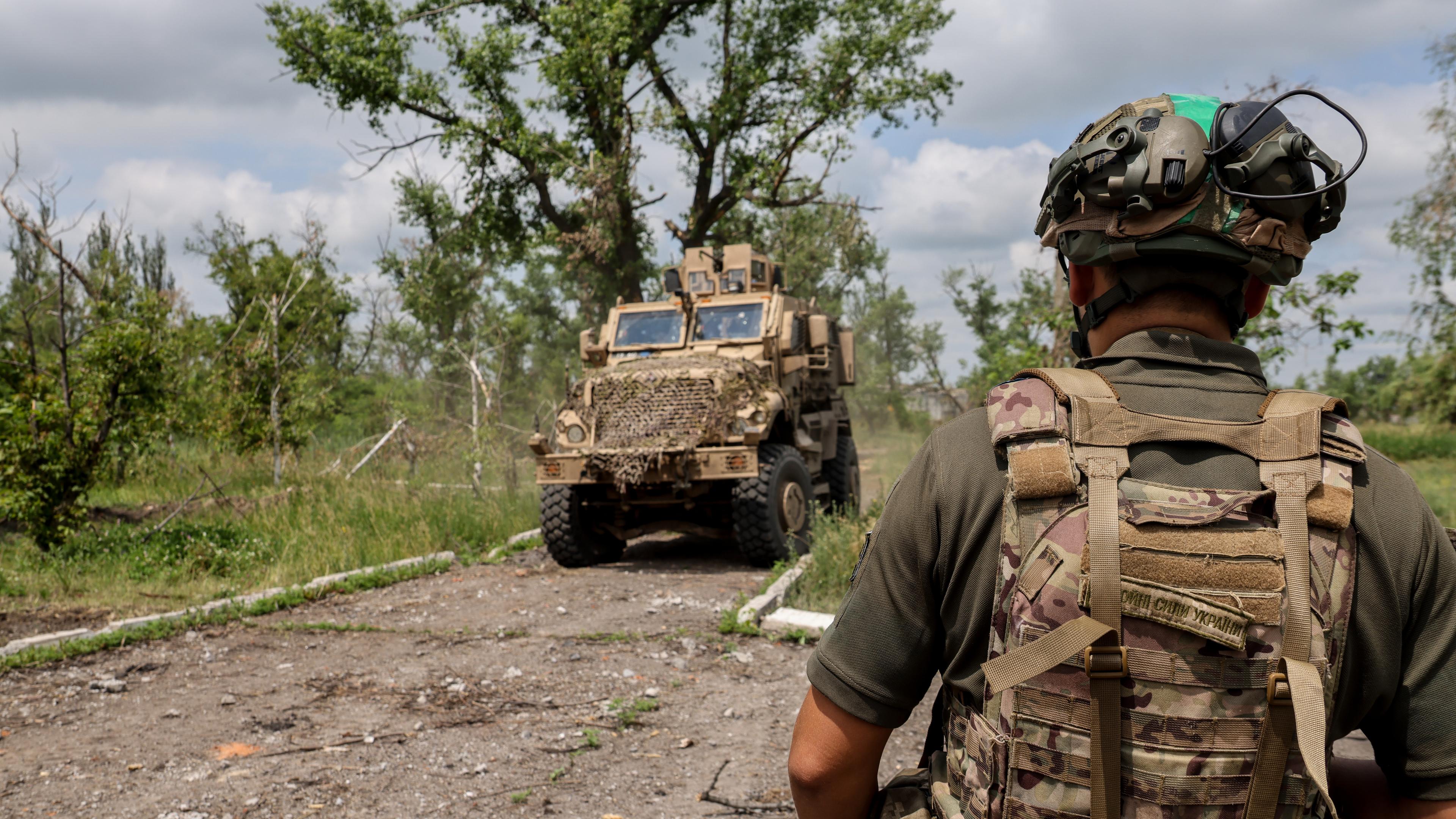 Ukrainischer Soldat vor Militärfahrzeug im Donezk