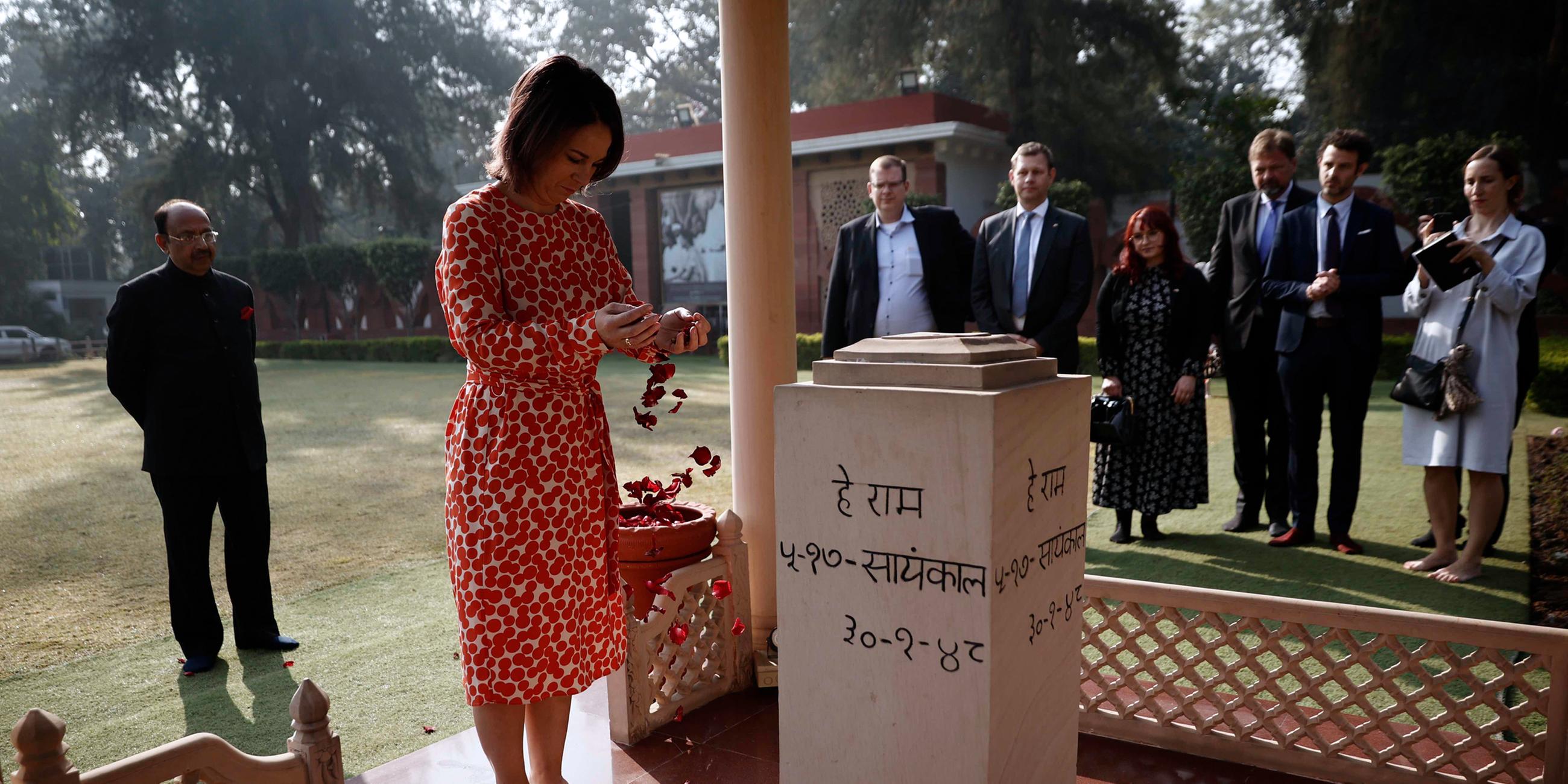 Außenministerin Annalena Baerbock verstreut Rosenblätter im Gedenken an Mahatma Gandhi im Innenraum der Gedenkstätte Gandhi Smriti.