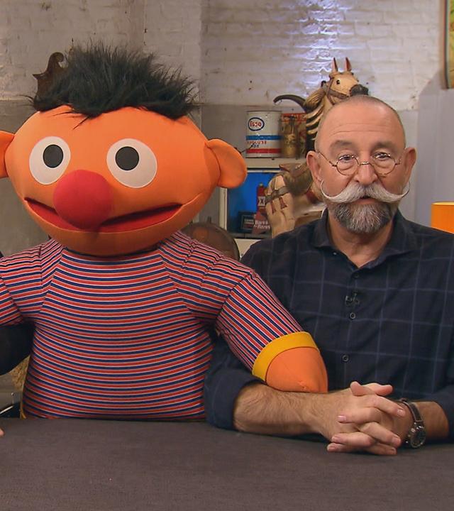 Sven Deutschmanek und Horst Lichter stehen mit einer großen "Ernie"-Stoffpuppe am Pult des Experten.