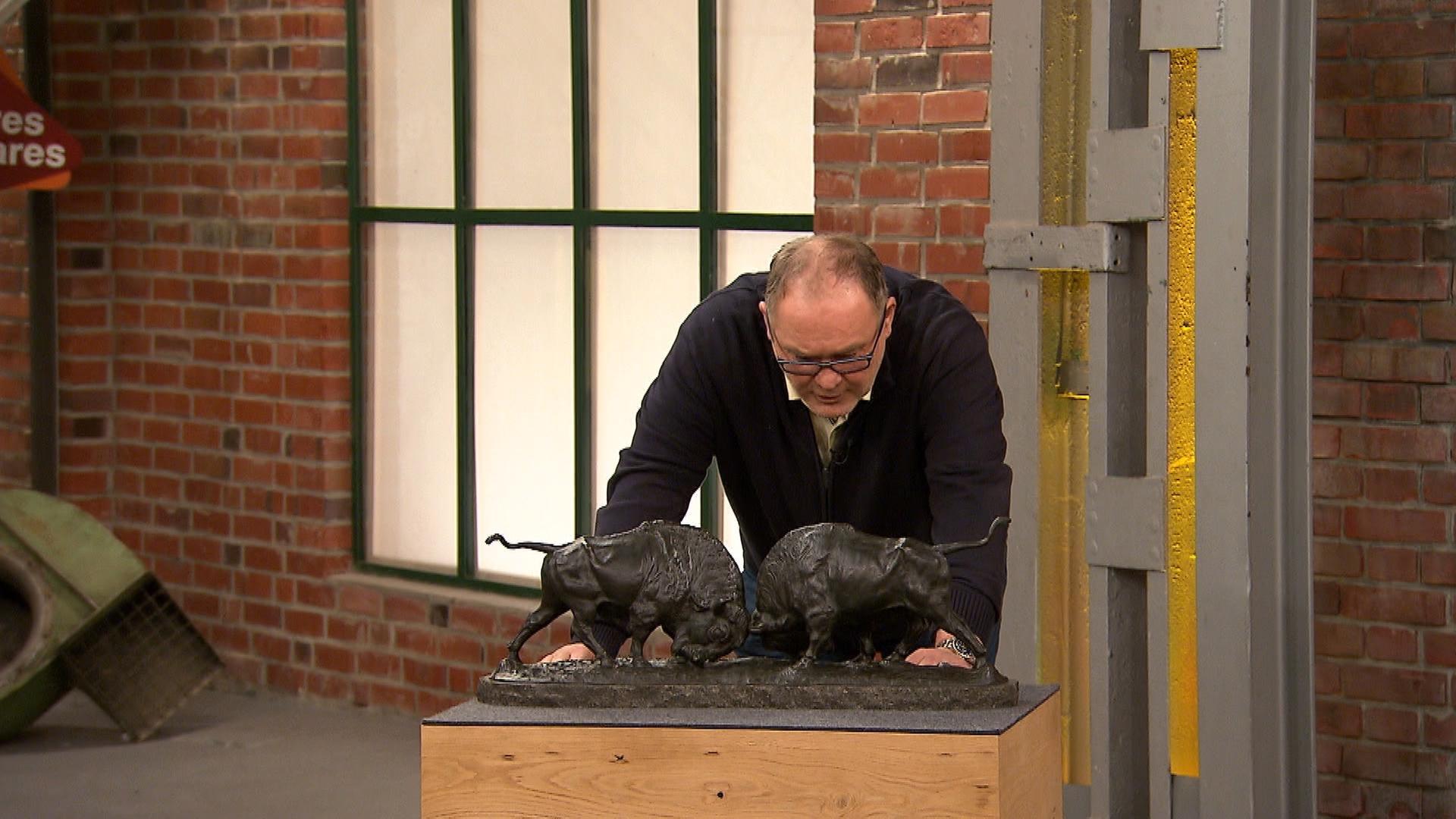 Händler Walter "Waldi" Lehnertz betrachtet eine Bronzefigur