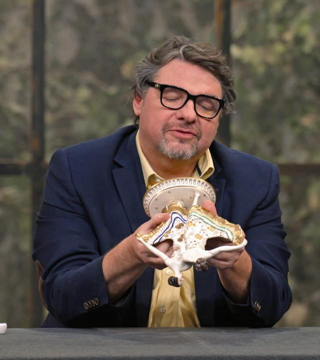 Lisa Nüdling, Daniel Meyer und Jan Cizek begutachten eine antike Porzellanfigur.