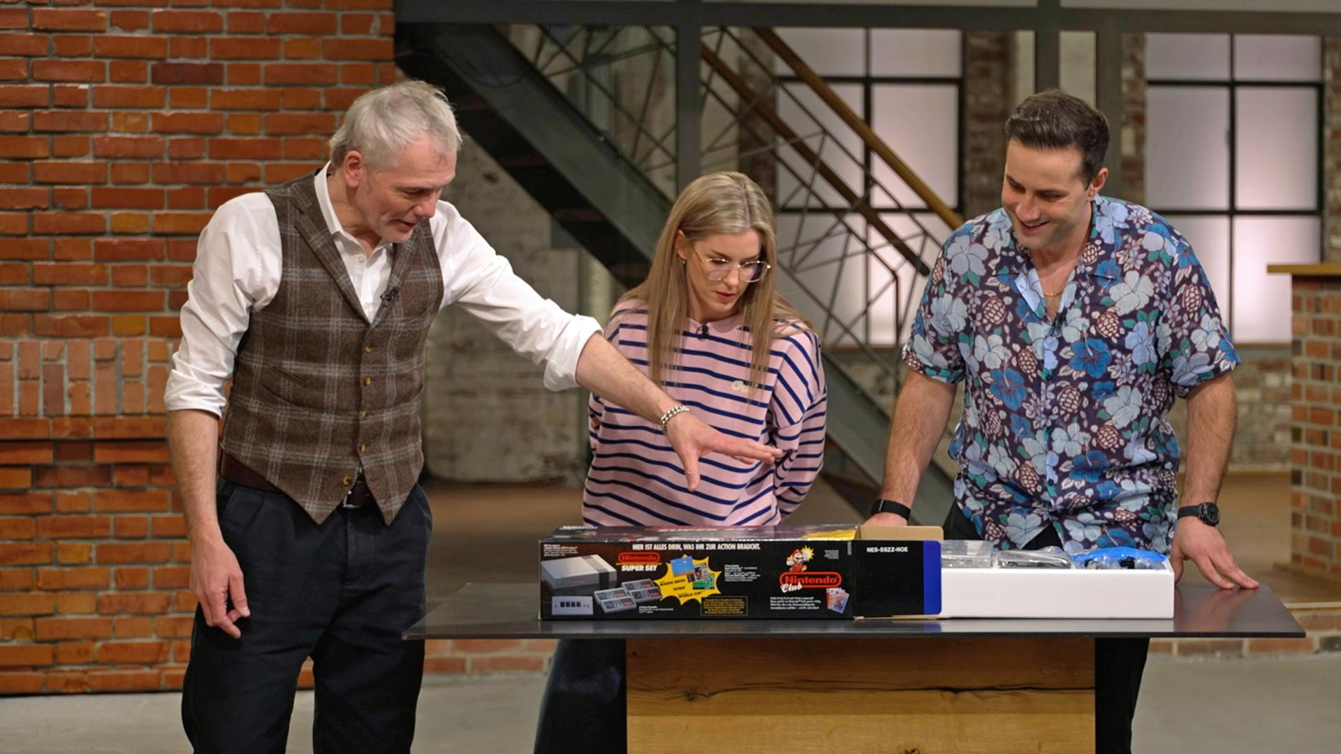 Christian Vechtel, Liza Kielon und David Suppes mit einem "Nintendo Entertainment System" von 1991 