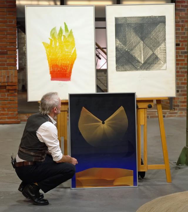 Christian Vechtel begutachtet Drucke des Künstlers Heinz Mack.