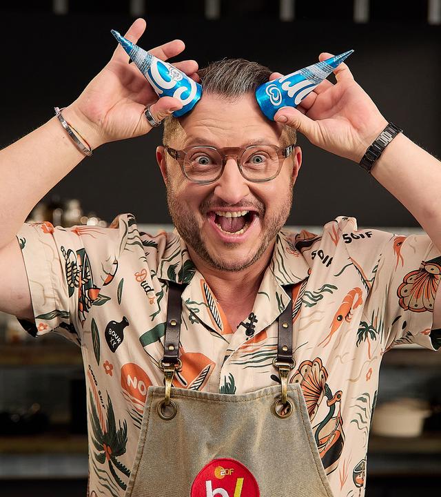 Sebastian Lege, wie er sich zwei Langnese Eiscreme-Verpackungen als Hörner an die Stirn hält.