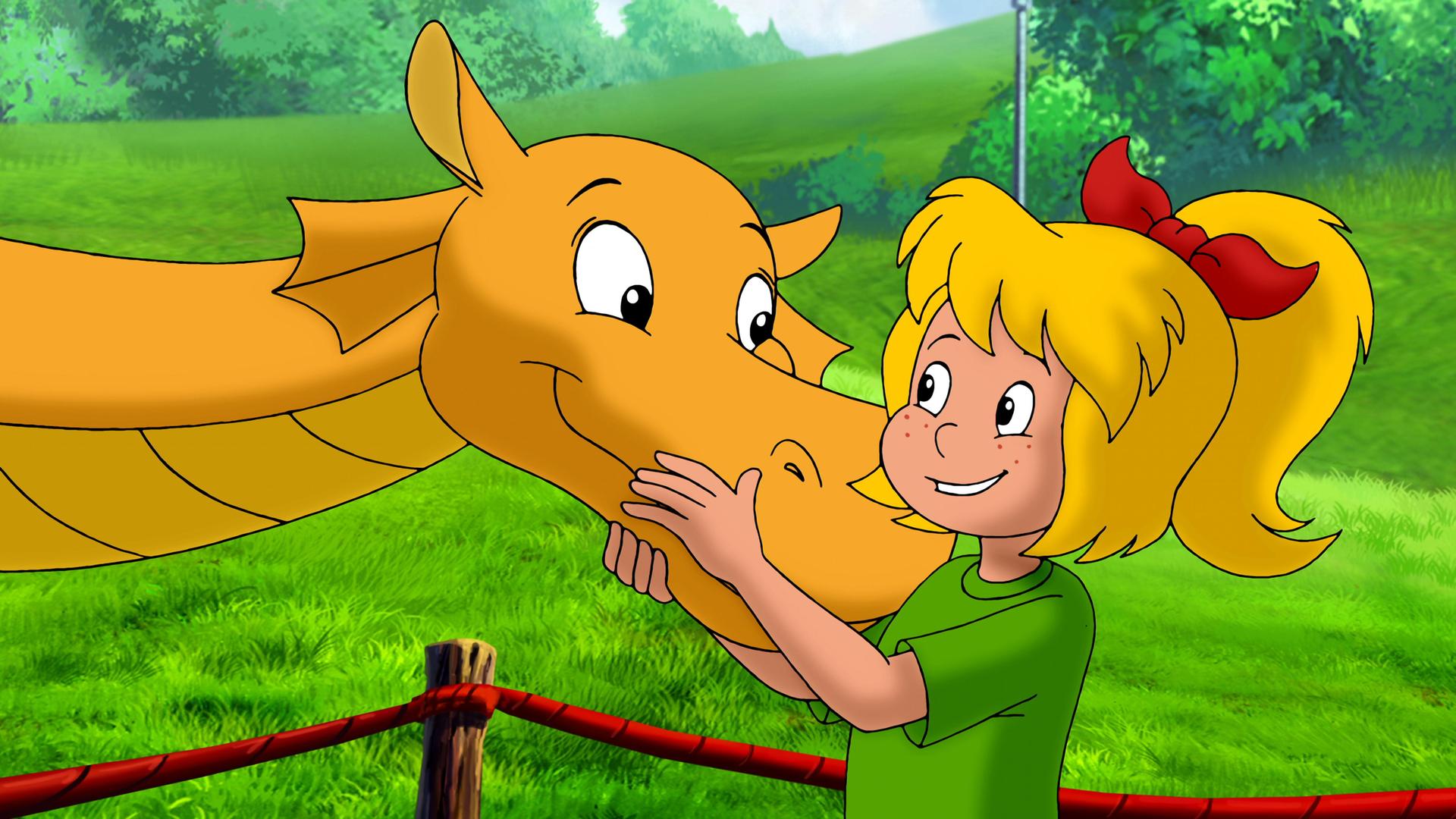 Bibi und der orangene Drache umarmen sich.