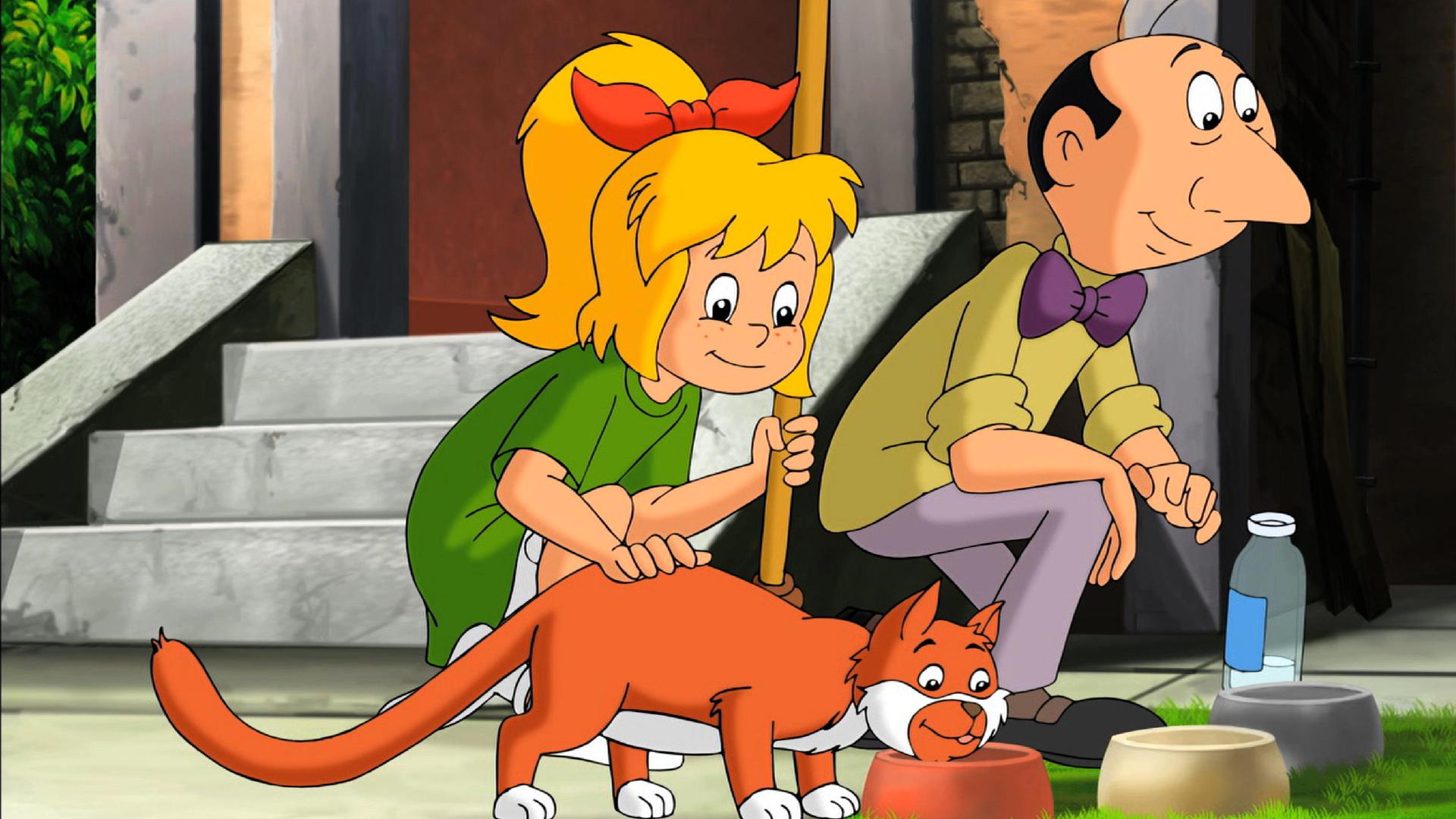 Bibi streichelt eine Katze, die von Herrn Pichler gefüttert wird.