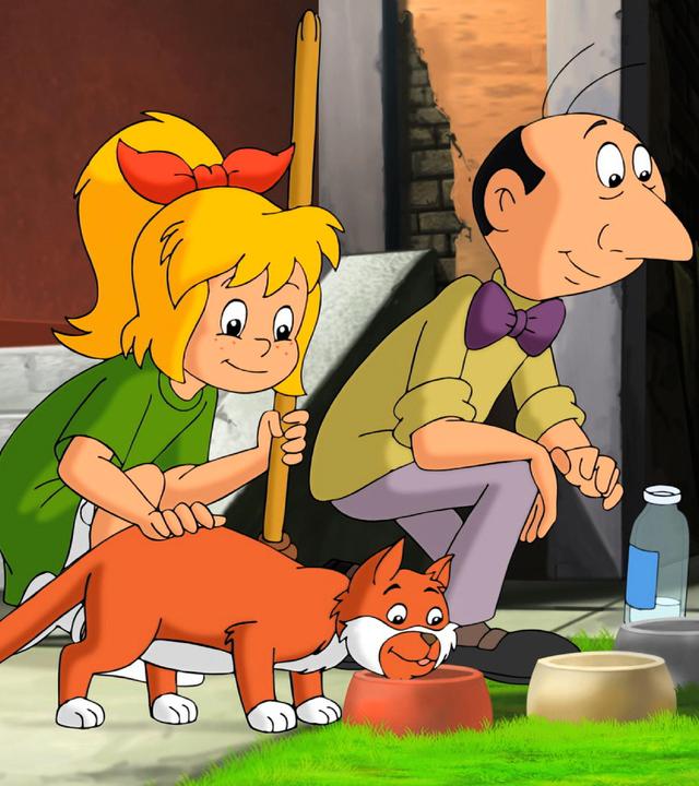 Bibi streichelt eine Katze, die von Herrn Pichler gefüttert wird.