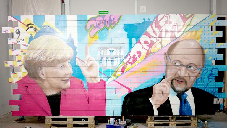 "Macht! Kampf! Wahl! - Merkel gegen Schulz": Wandgemälde mit den Köpfen von Angela Merkel und Martin Schulz.