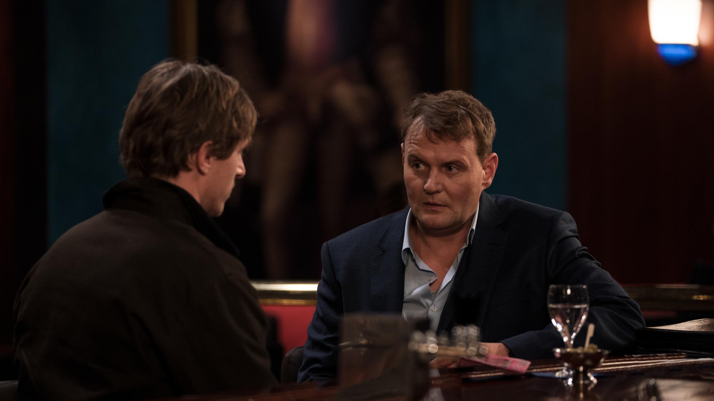 "Schwartz & Schwartz - Mein erster Mord": Das Brüderpaar Mads (Golo Euler) und Andi Schwartz (Devid Striesow) sitzen an der Theke einer Bar und sprechen miteinander.