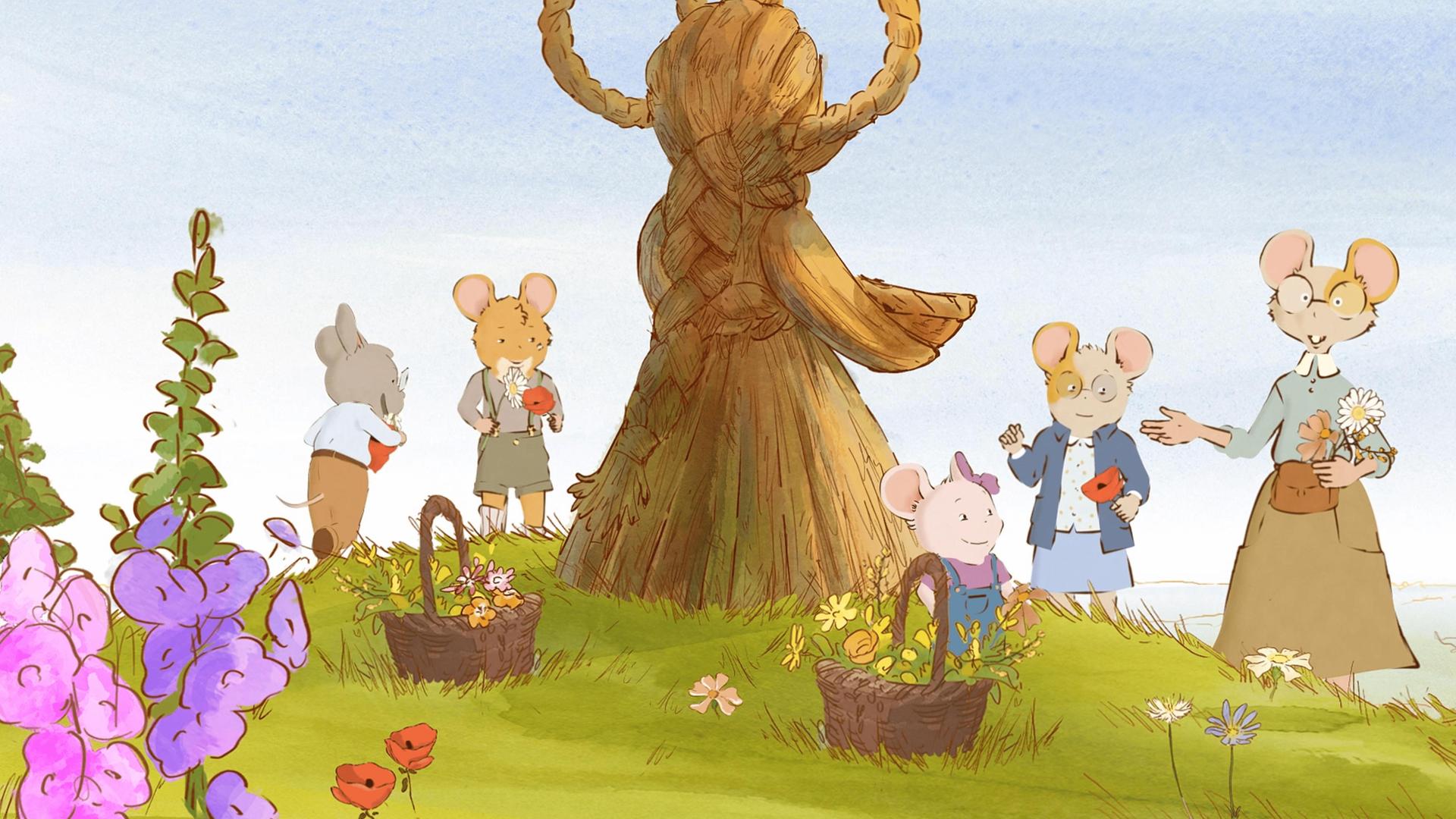 Auf einer schönen, grünen Wiese mit Blumen und Klatschmohn, steht eine schöne, sehr große, aus Stroh geformte Skulptur. Rund um diese Skulptur haben sich Marcelle mit ihren Töchtern, sowie Celestine und Augustin versammelt. Auf der Wiese stehen auch zwei Weidenkörbe mit gepflückten Blumen drin.