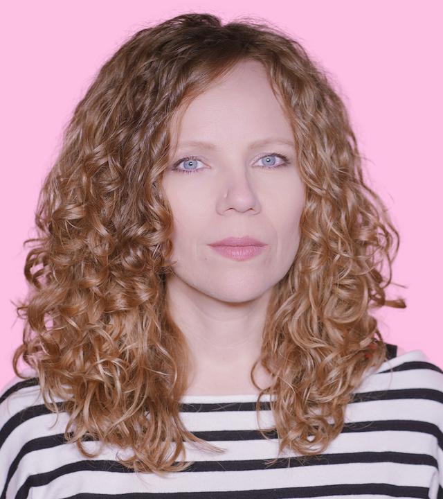 Sarah Bosetti befindet sich vor einem rosa Hintergrund. Rechts von ihr in einer Blase ist Konstantin Wecker abgebildet.