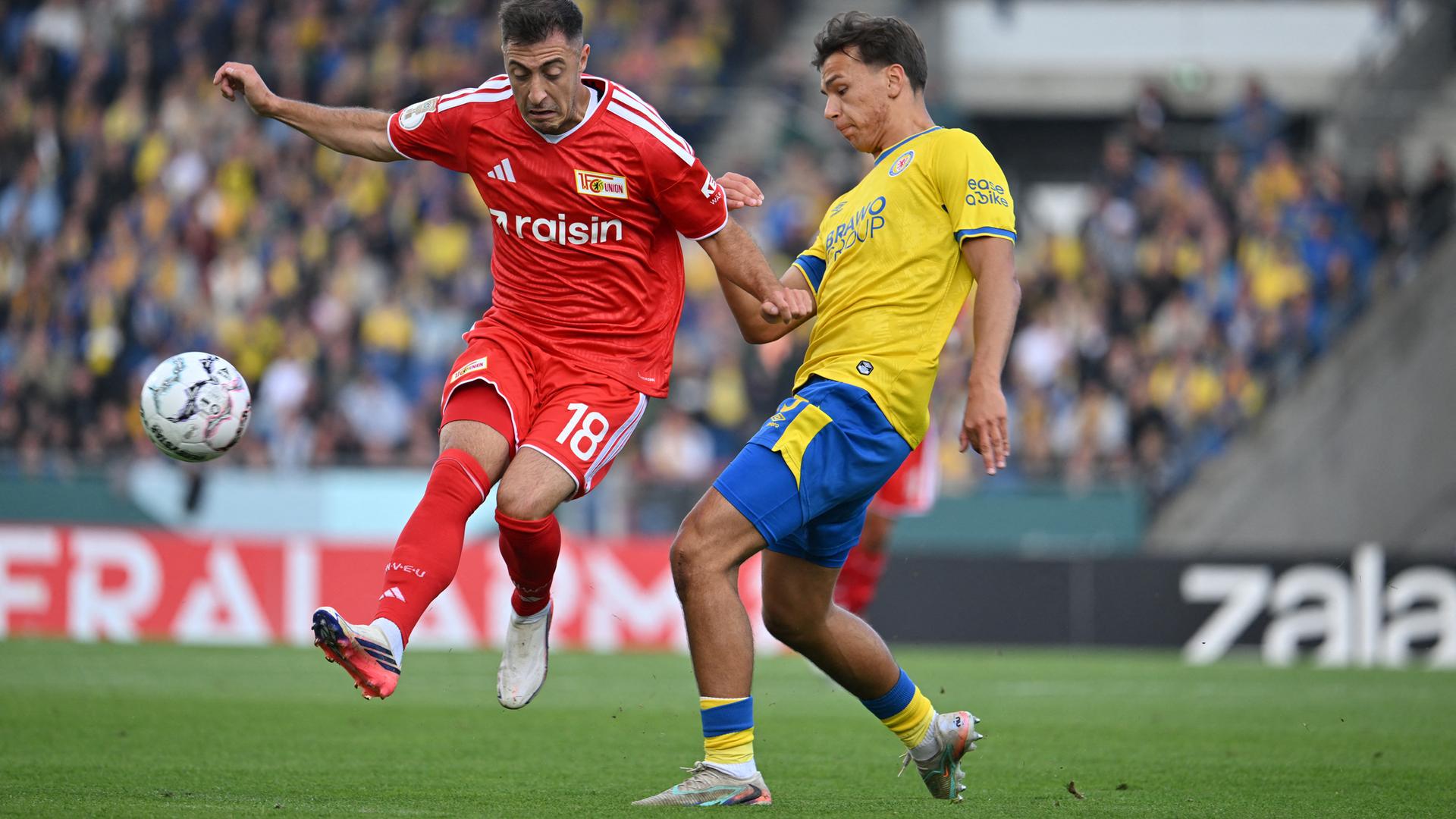 Josip Juranović (1. FC Union Berlin) und Josip Juranović (1. FC Union Berlin) und Max Marie (Eintracht Braunschweig)  (Eintracht Braunschweig)  kämpfen im DFB-Pokal um den Ball.
