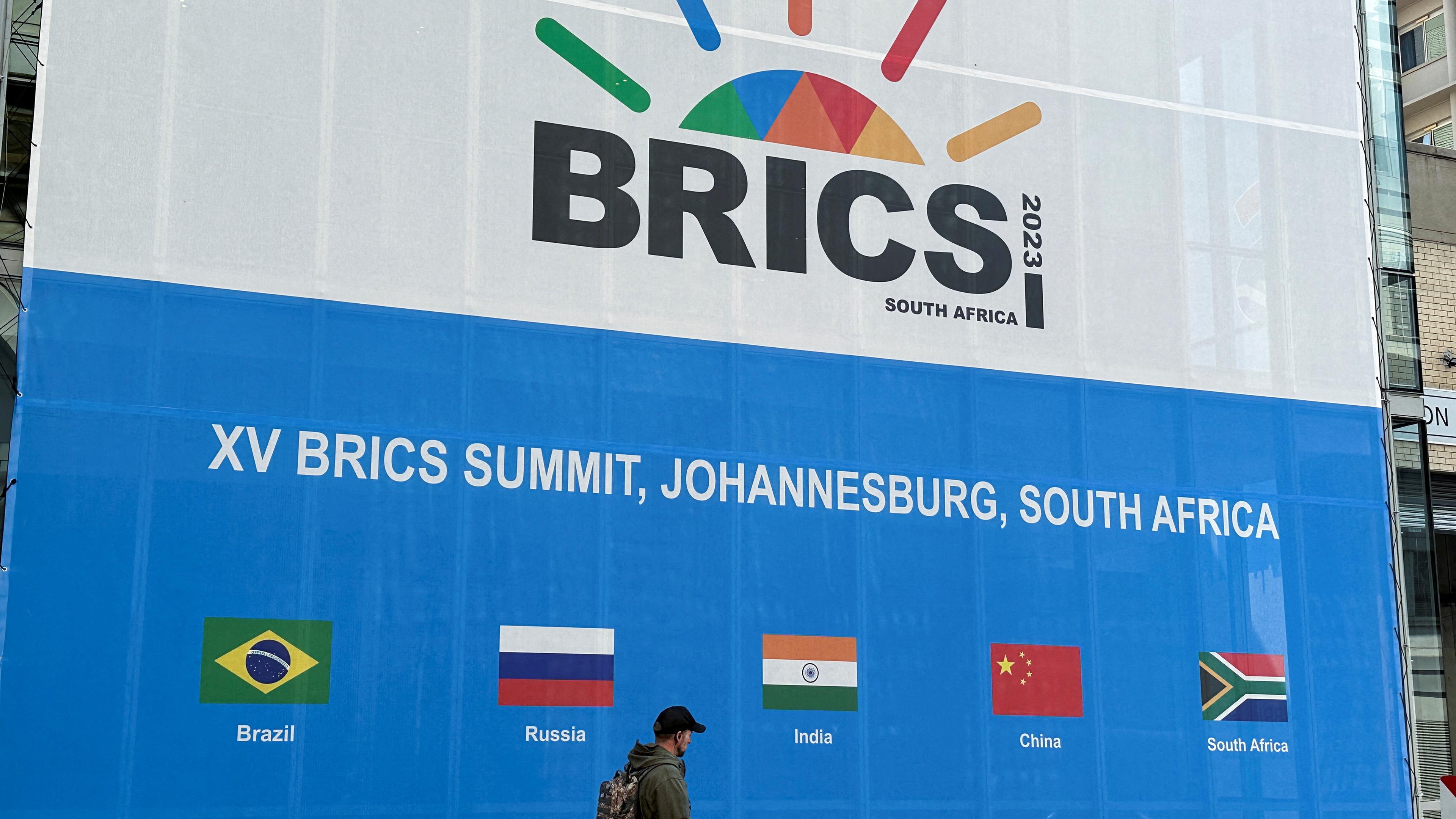 A person walks past the Sandton Convention Centre, which will host the upcoming BRICS Summit, in Johannesburg, South Africa August 19, 2023.