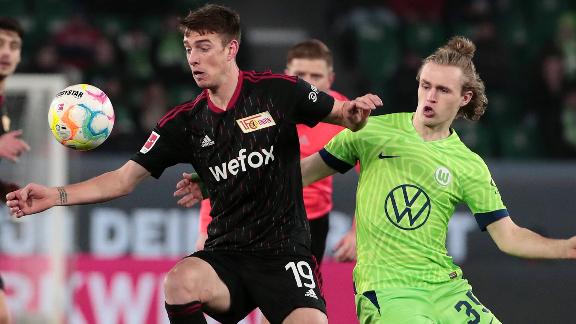 12.03.2023, Wolfsburg: Janik Haberer (Union Berlin) im Zweikampf mit Patrick Wimmer (VfL Wolfsburg)