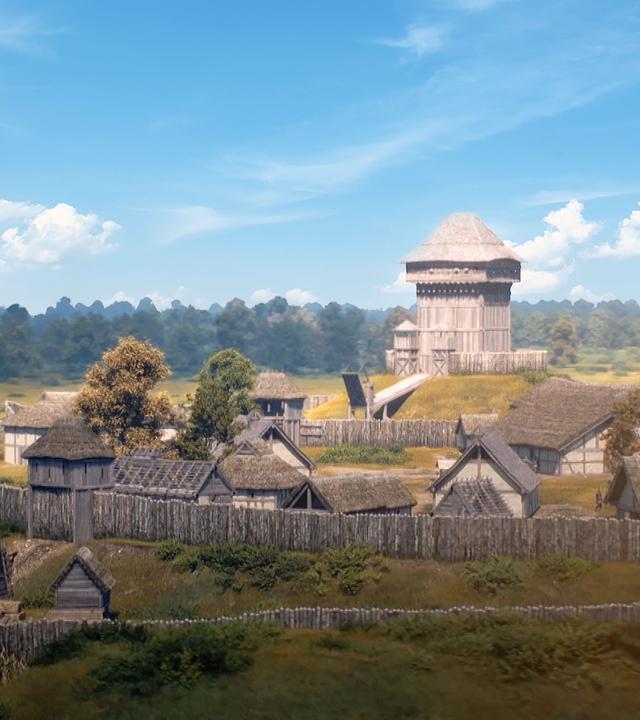 Eine computergenerierte Nachbildung einer mittelalterlichen Burganlage mit Holzpalisade.