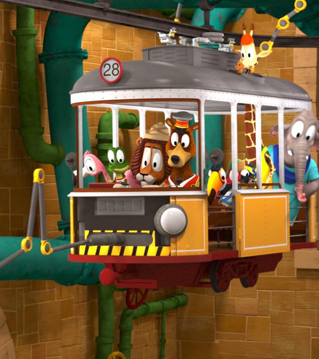 Die Zoobande sitzt in ihrem Bahnabteil und fährt durch ein Tunnelsystem. Ein mechansicher Greifarm, der vorne am Bahnabteil befestigt ist, greift nach etwas.