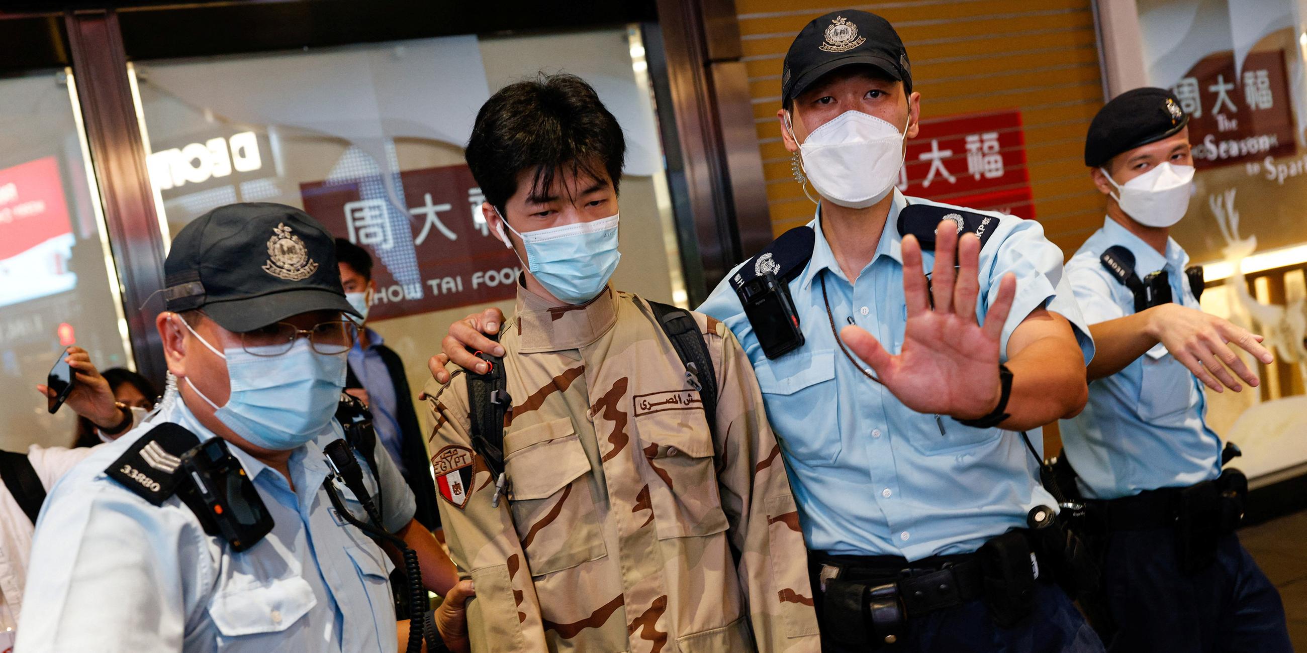 Polizisten verhaften einen Demonstranten in Hong Kong