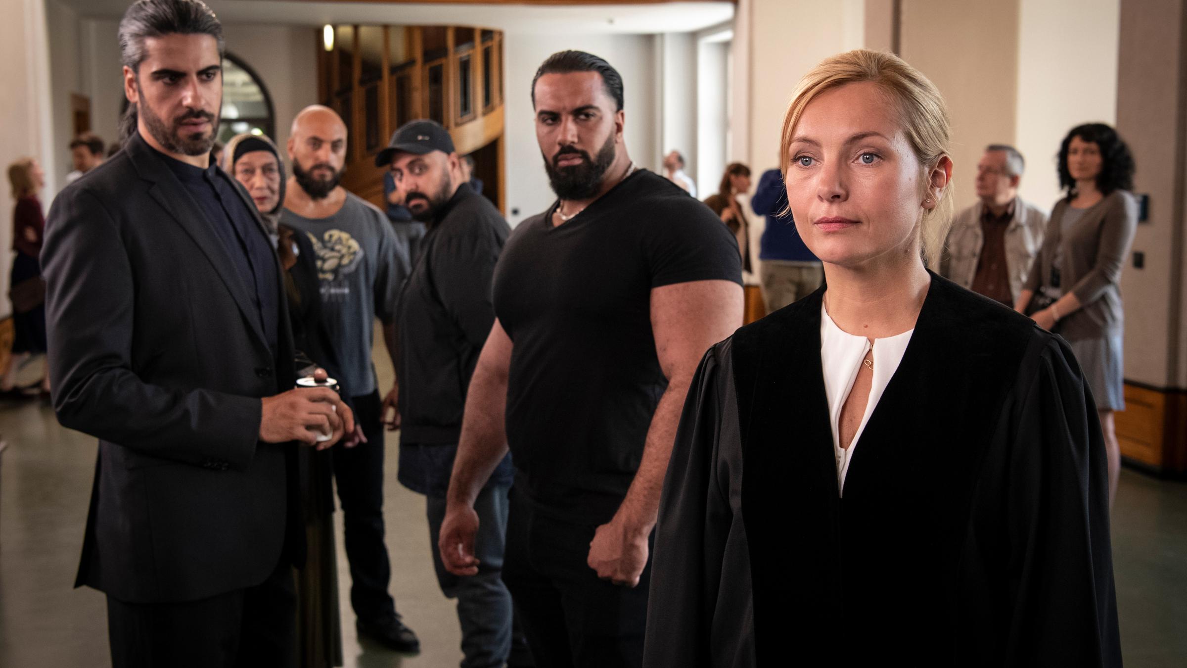 "Gegen die Angst": Vor der Gerichtsverhandlung: Staatsanwältin Judith Schrader (Nadja Uhl) wird von den Al-Fadi-Clanmitgliedern und ihrem Chef (Atheer Adel) kritisch beäugt.