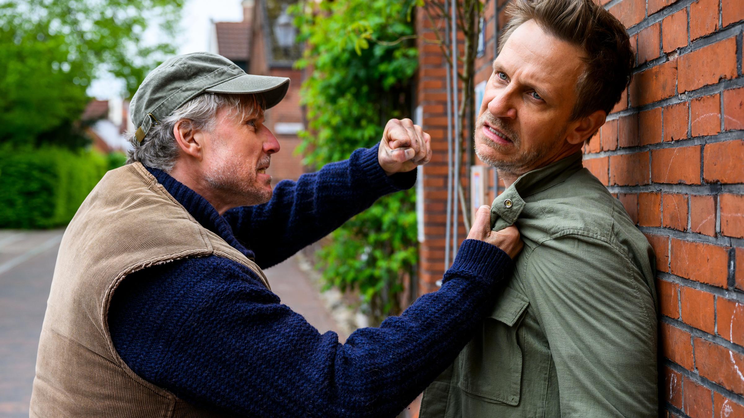 "Friesland - Artenvielfalt": Oliver Borchers (Dirk Borchardt) bedroht Erik Thomsen (Mike Hoffmann) vor einer Hauswand mit der Faust.