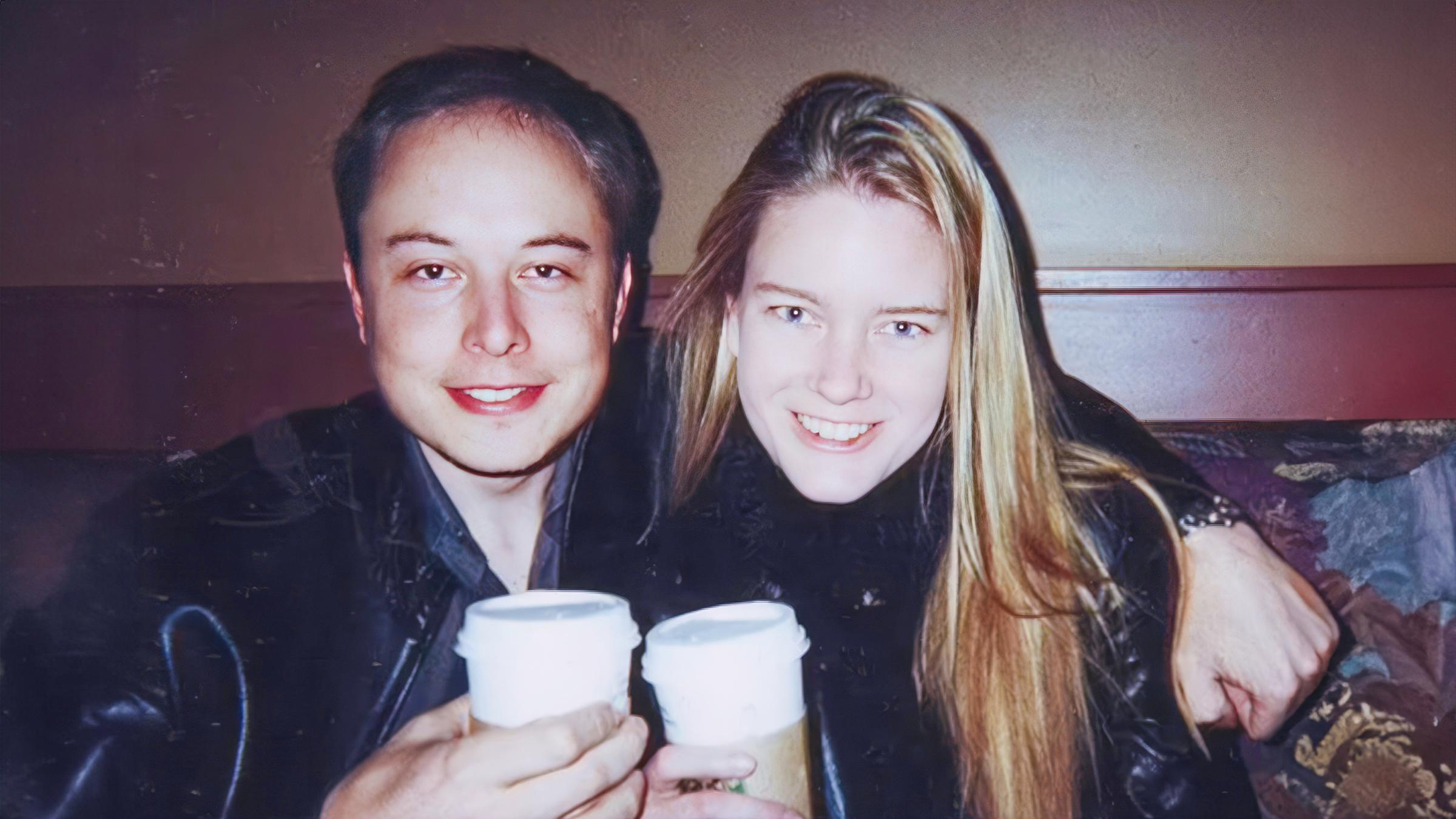 "Elon Musk - Genie und Wahnsinn - Träume": Elon Musk und Justine Wilson sitzen nebeneinander und lächeln in die Kamera. Elon Musk hat seinen Arm um Justine Wilson gelegt und sie halten beide Kaffeebecher in den Händen.