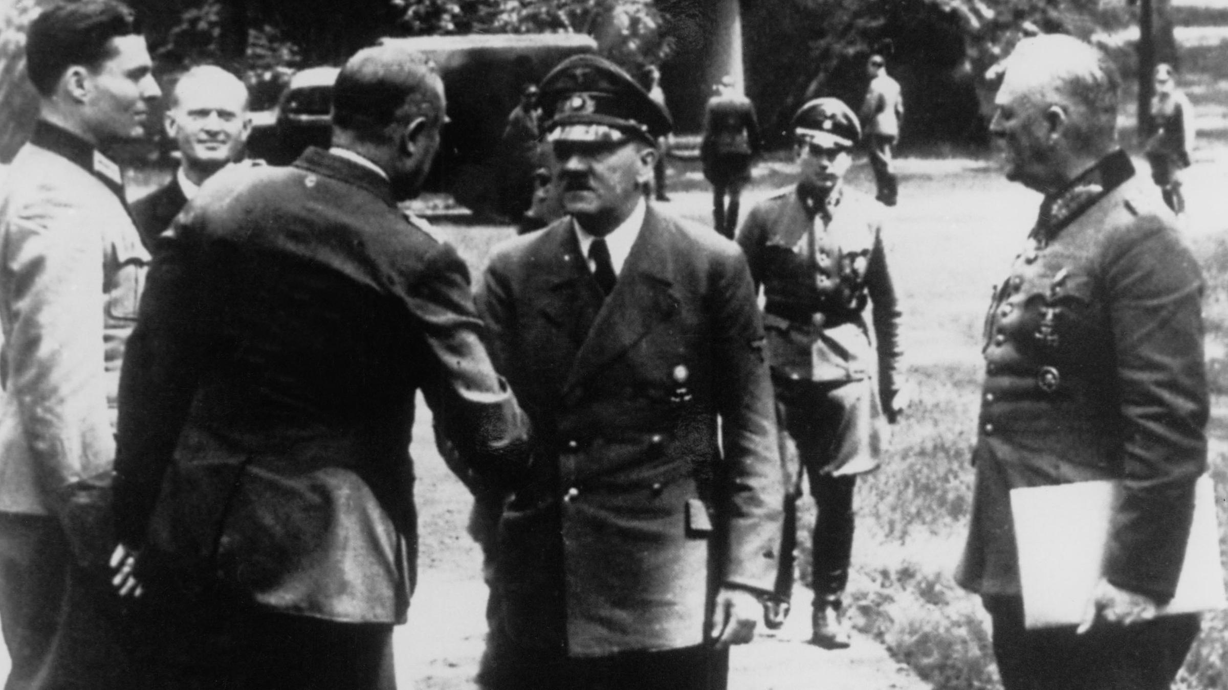 "Attentat auf Hitler - Stauffenberg und der deutsche Widerstand": Historische Schwarz-Weiß-Aufnahme: Eine Gruppe von Offizieren begrüßt Hitler am 15. Juli 1944 vor Hitlers Hauptquartier "Wolfschanze".