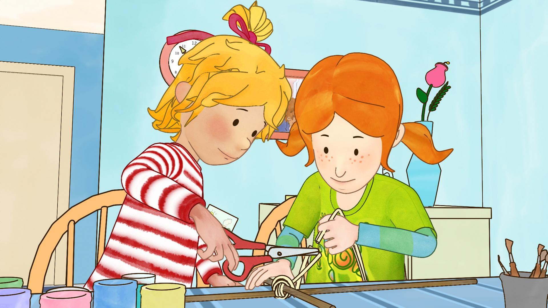 Conni (links) bastelt mit Anna (rechts) einen Drachen. Anna umwickelt die beiden Holzstangen mit Kordel, Conni schneidet mit der Schere.