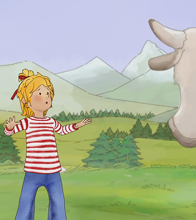 Conni erschrickt, weil sie auf eine Kuh trifft, die plötzlich vor ihr steht. Im Hintergrund ist eine Berglandschaft zu sehen.