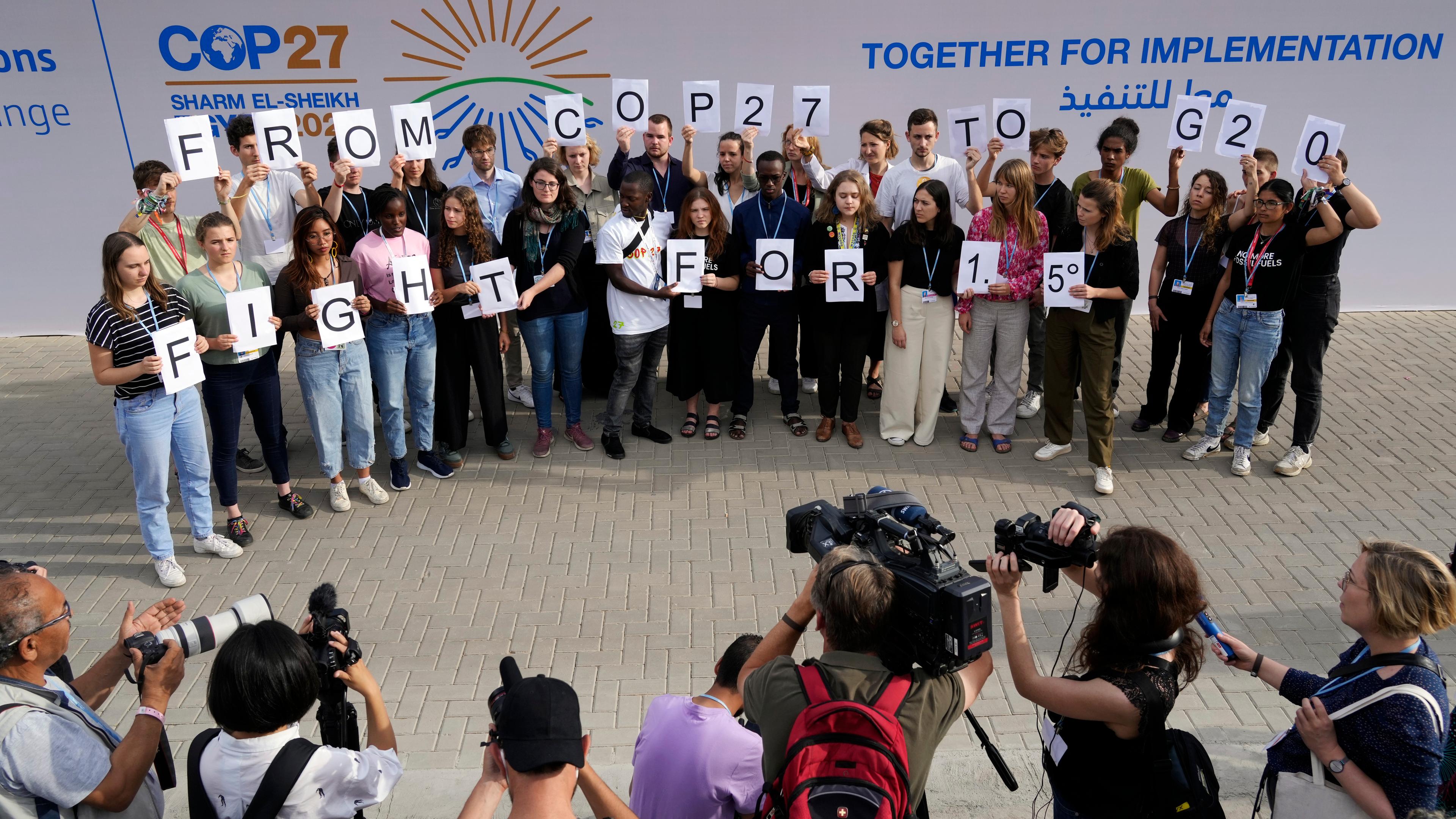 Ägypten, Scharm El Scheich: Junge Klimaaktivisten halten Schilder mit der Aufschrift "From COP27 To G20 Fight For 1.5" beim UN-Klimagipfel COP27.