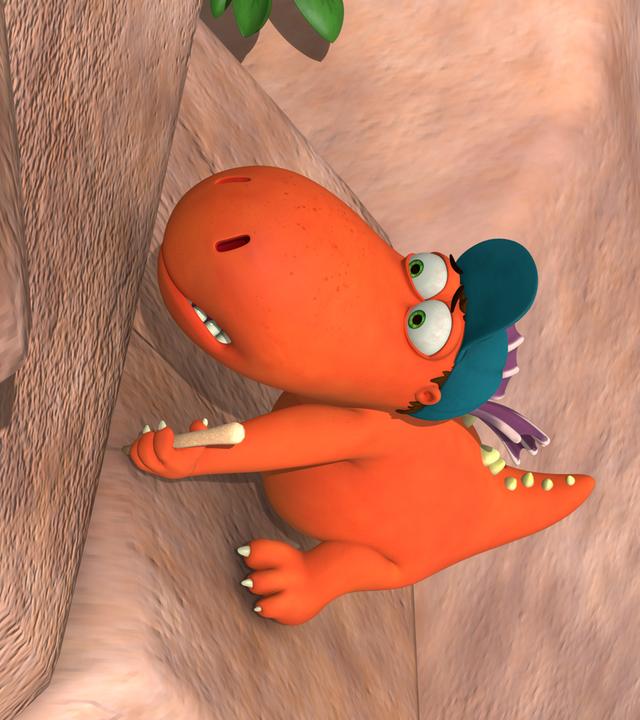 Drache Kokosnuss klettert eine Felswand empor. Er versucht sich an den Felsen festzuhalten und macht dabei ein verängstigtes Gesicht.
