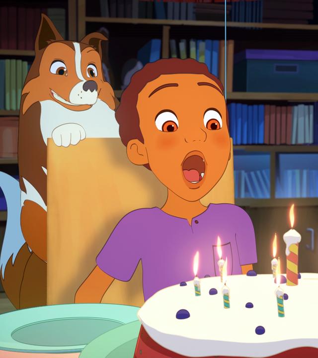 Harvey ist dabei die Kerzen auf seinem Geburtstagskuchen auszupusten und holt dafür tief Luft. Lassie schaut über seine Schulter.