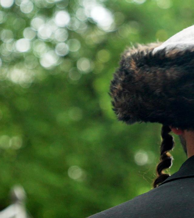 Ein Mann mit traditioneller jüdischer Kopfbedeckung von hinten